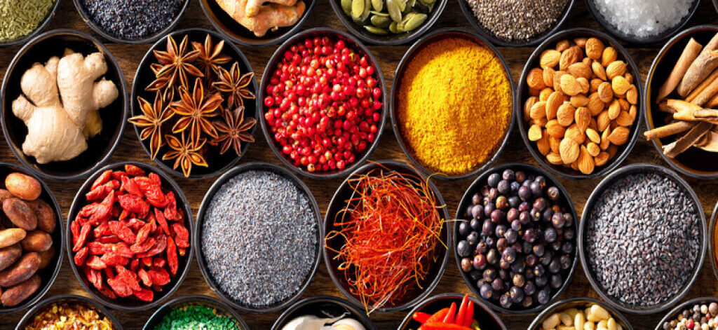 Colourful background from various herbs and spices for cooking in bowls