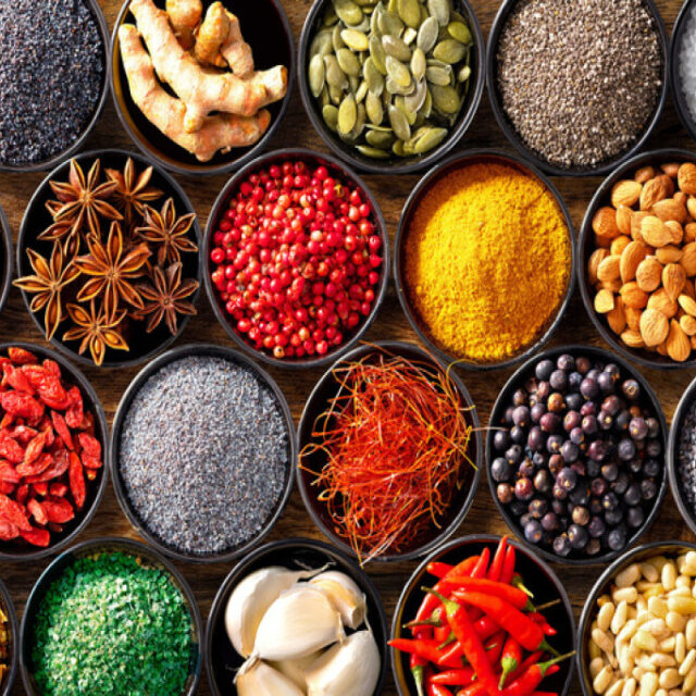 Colourful background from various herbs and spices for cooking in bowls