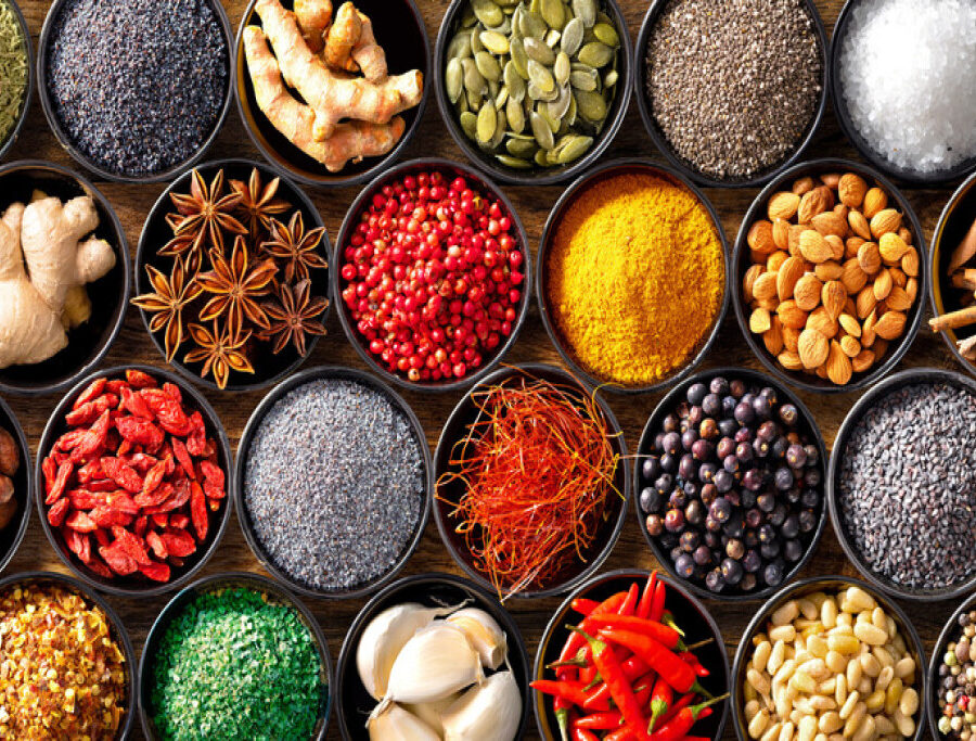 Colourful background from various herbs and spices for cooking in bowls